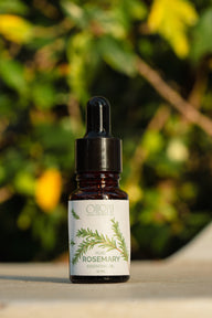 Oilori 10ml bottle of rosemary essential oil with a dropper on a natural background